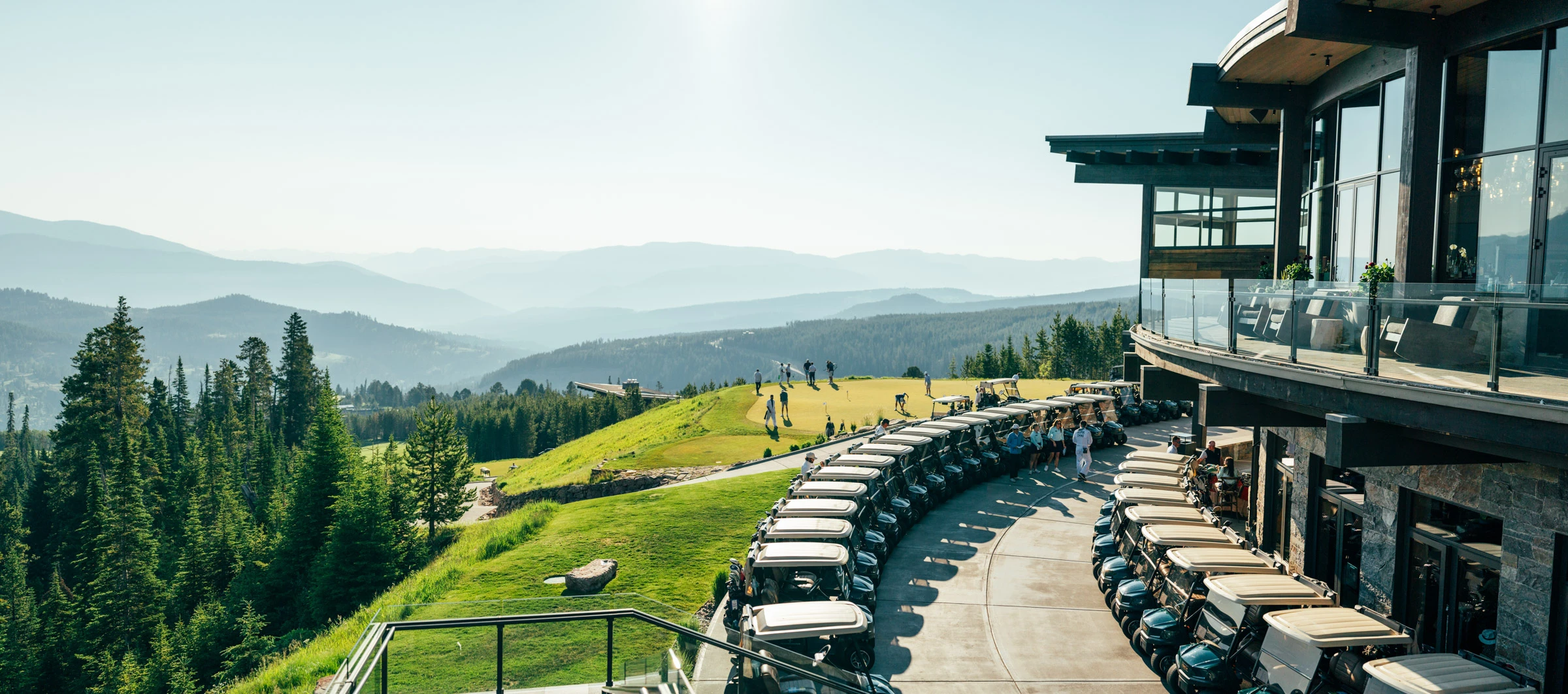 High-end real estate master bedroom with vaulted ceiling, warm timber accents and panoramic mountain views